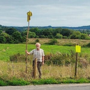 Jeremy Milln at the proposed site showing just how tall the transformers would be